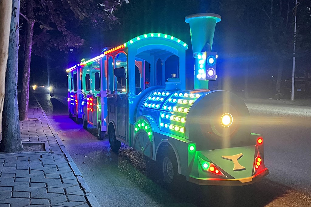 Mini electric train trackless ride with colorful LED lights at night for amusement park