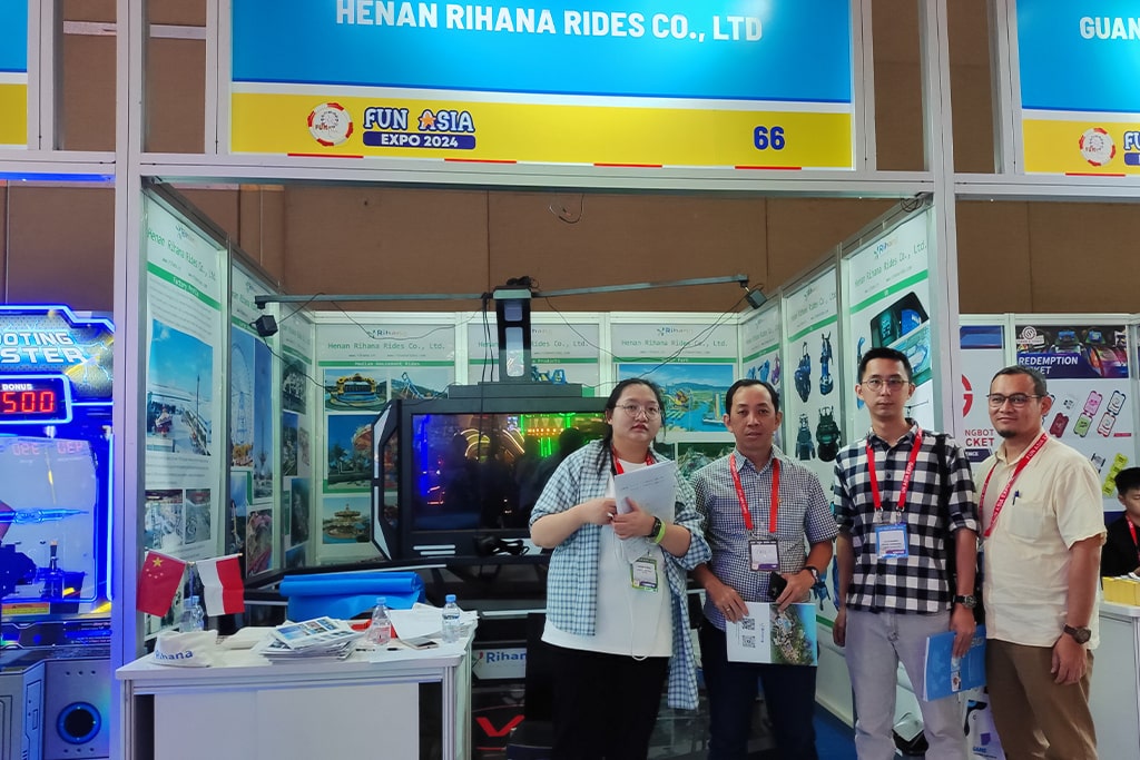 Customer exploring amusement park train rides and taking a photo with our team at trade show