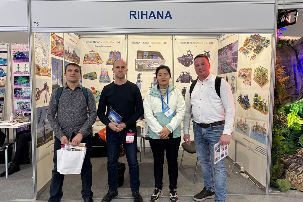 Group photo with three clients inquiring about water amusement park rides at the exhibition