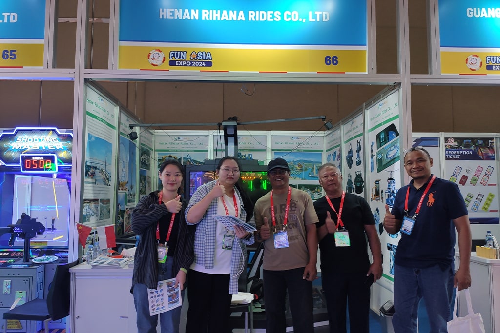 Three customers interested in water amusement rides take a photo with our sales team at exhibition