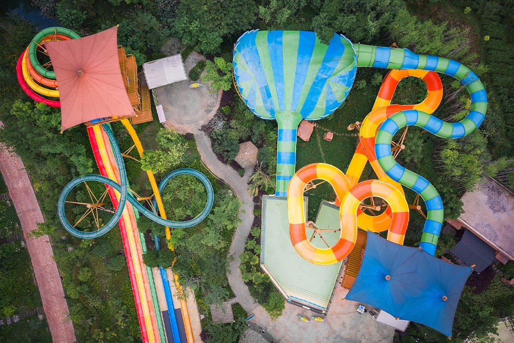 Different types of fiberglass water slides in a water park, durable water park equipment designed for safety and fun.