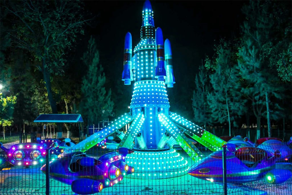 Airplane Amusement Ride with colorful lights at night