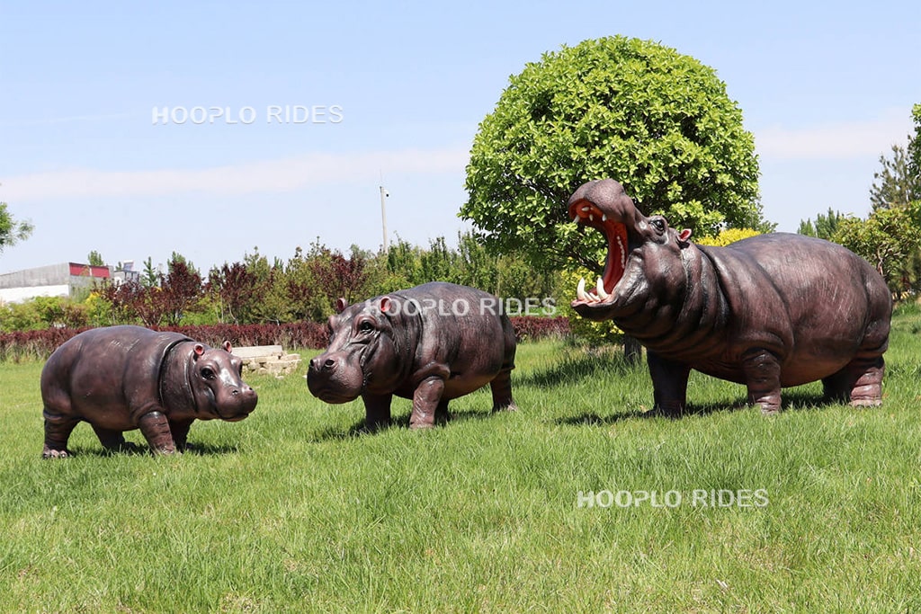 Three fiberglass hippo statues for garden decoration