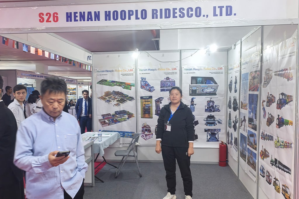 Overview of Hooplo Rides booth showcasing amusement rides at the Uzbekistan–China Brand Products Exhibition 2025