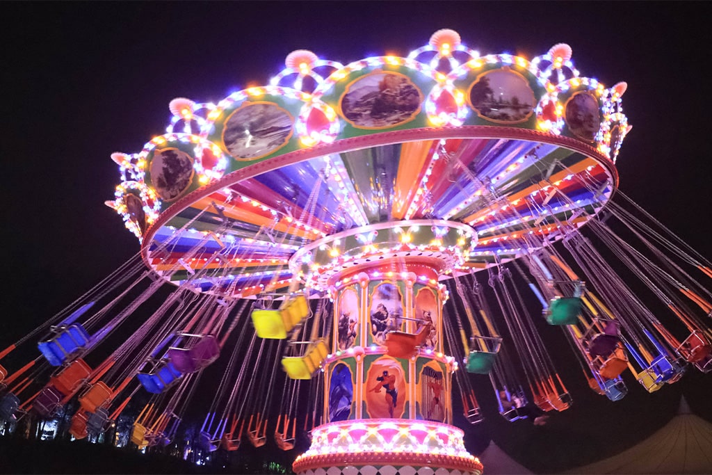 Swing carousel decorated with bright lights at night