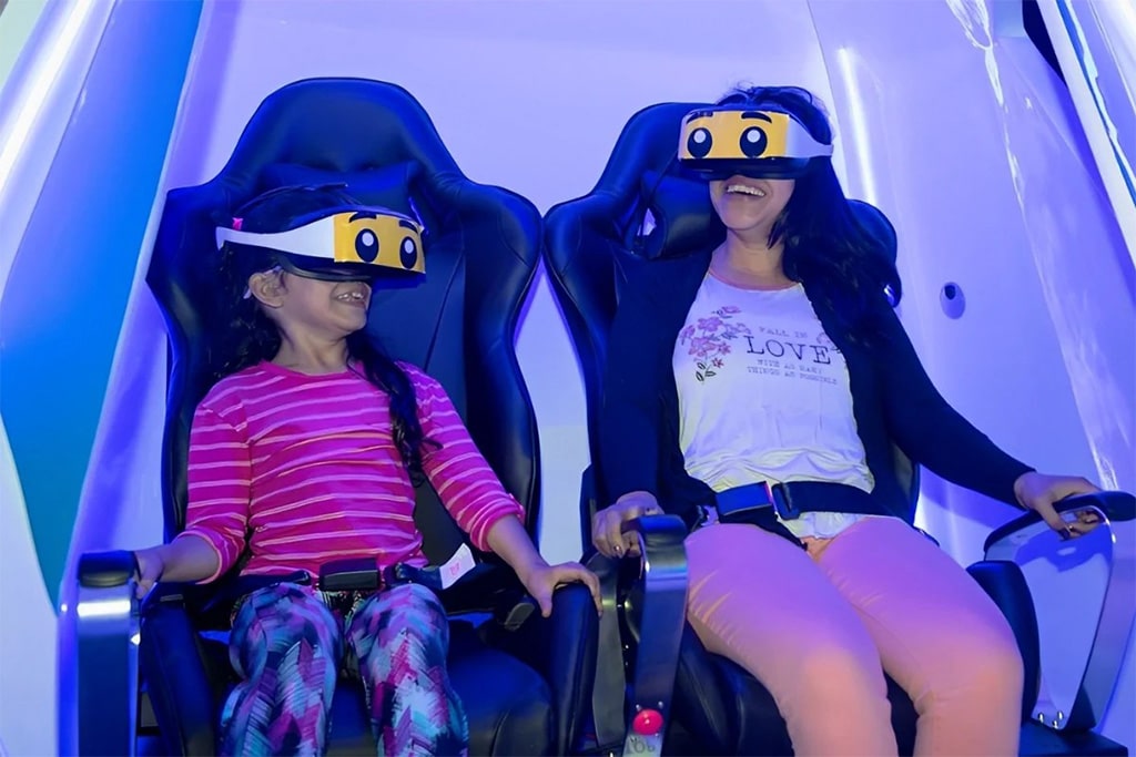 Adults immersed in a virtual reality experience, exploring new worlds in a safe and exciting indoor playground.