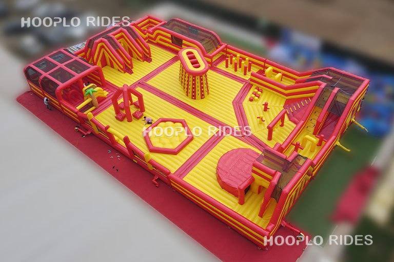 Front appearance of the Mega Inflatable Obstacle Course Park showing its large adventure layout, multi-lane activities, and central climbing tower