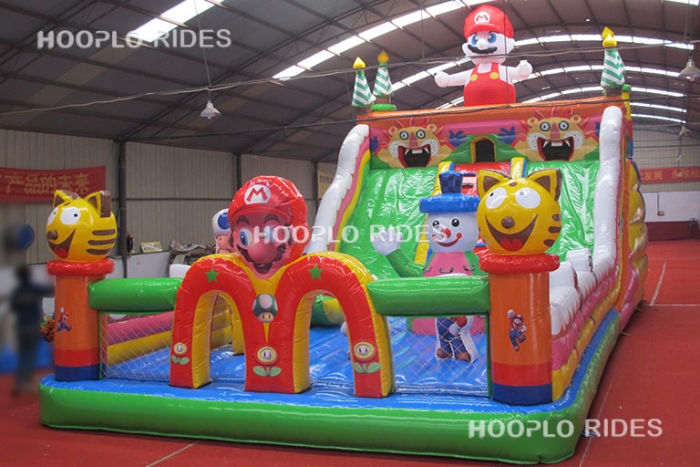 Left view of a mario style inflatable slide, showing the tall inflatable sliding structure