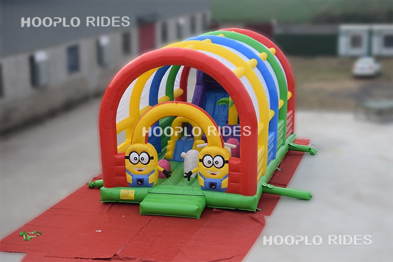 Left view of a minion style inflatable castle with roof, showing the covered inflatable structure