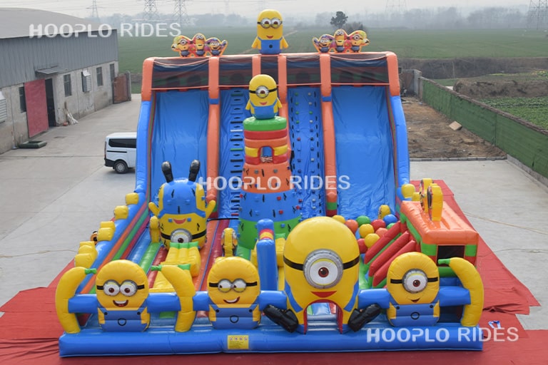 Main front view of a Minions theme inflatable castle showing its playful cartoon design and spacious bouncing section.