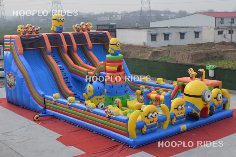 Right side view of a Minions theme inflatable castle with detailed Minions-themed graphics and a durable bounce construction.