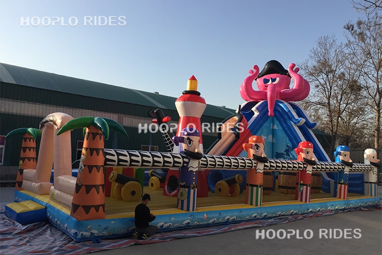 Side view of octopus pirate inflatable castle showing slide and play structure layout