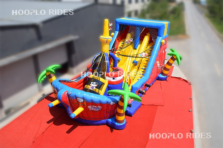 Side view of pirate ship inflatable castle showing slide and climbing play structure