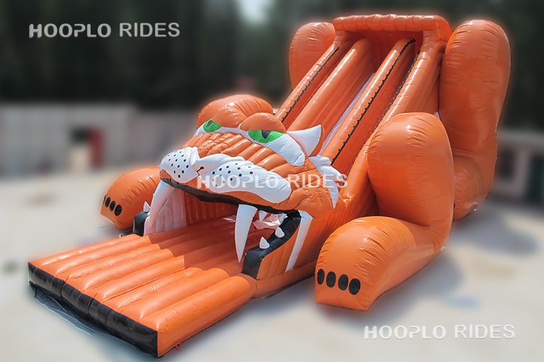 Left view of tiger inflatable slide showing slide structure and animal-themed design