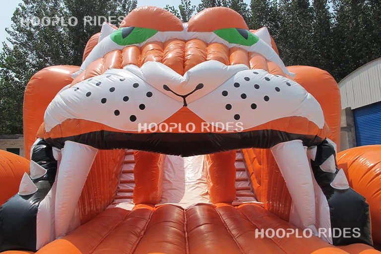 Close-up of tiger head entrance design on tiger inflatable slide highlighting themed entry