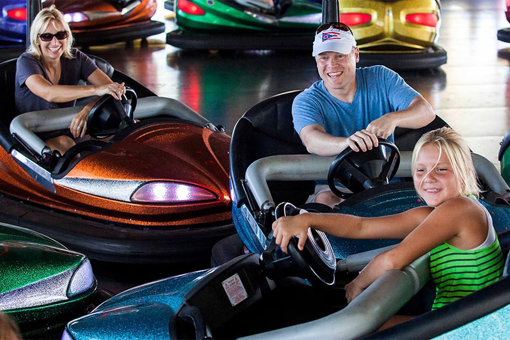 Adults enjoying an adult bumper car ride in an amusement park, built for higher load capacity and exciting driving experience