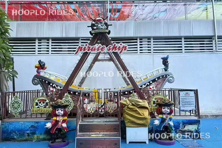 12 seat mini pirate ship ride mobile type in amusement park, front view showing swinging motion and family-friendly design