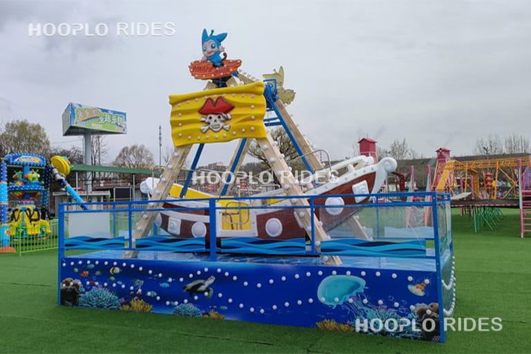 12 seat mini pirate ship ride mobile type installed in amusement park, side view showing structure and ride layout