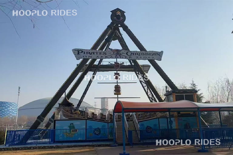 40 seat large pirate ship ride operating in amusement park, powerful swinging motion attracting crowds