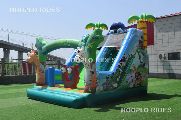 Left side view of Animal Paradise inflatable slide showing climbing steps and safety side walls.