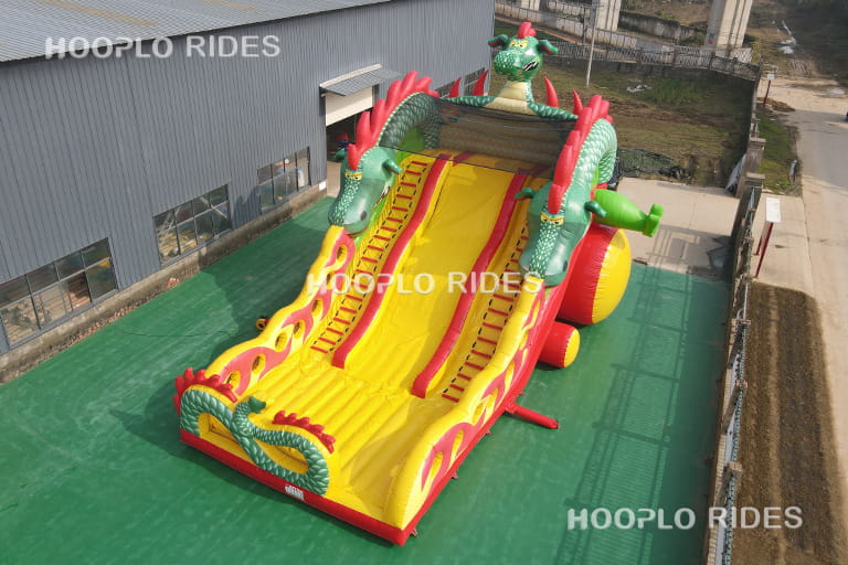 Left side view of dragon theme inflatable slide showing climbing area and slide structure design