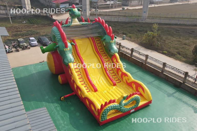 Right side view of dragon theme inflatable slide highlighting colorful dragon decoration and slide lane