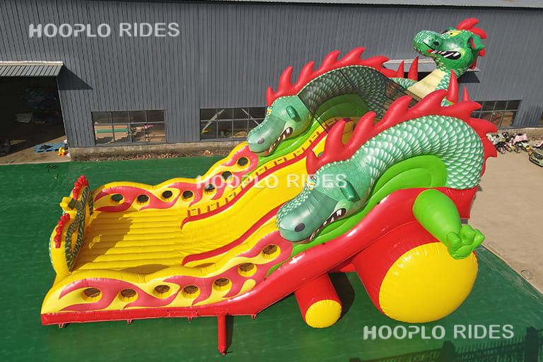 Side structure view of dragon theme inflatable slide displaying full height and safety side walls design