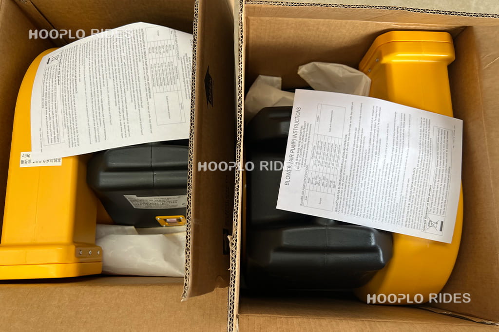 Two air blowers installed and prepared for shipping with inflatable playground