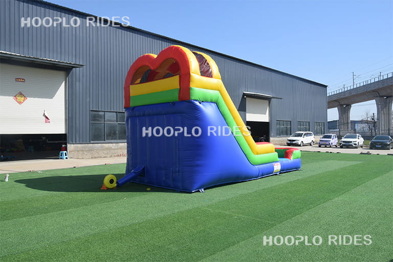 Back view of rainbow inflatable slide showing structure and safety design