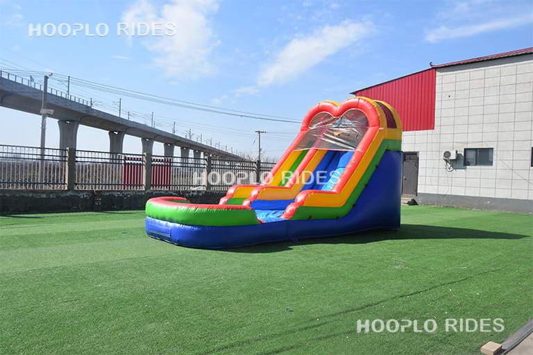 Left view of rainbow inflatable slide, large inflatable slide for outdoor events