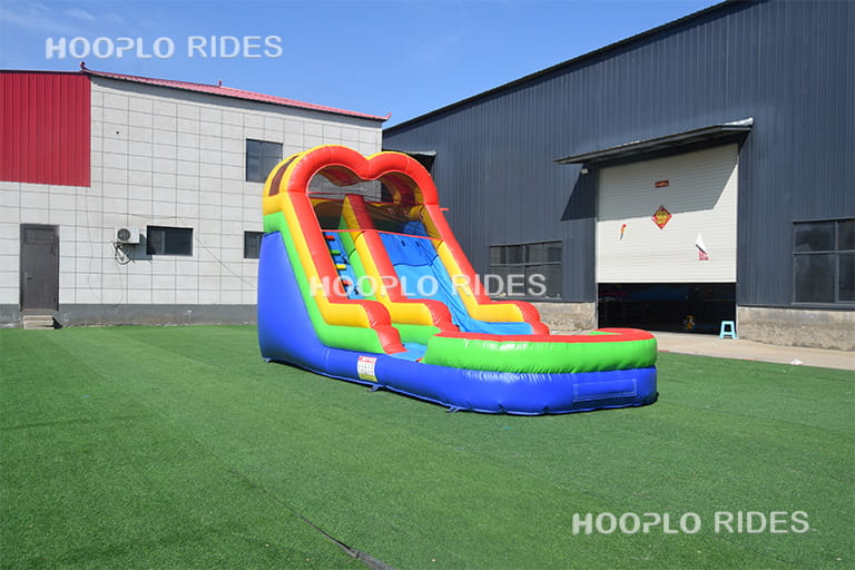 Main image showing right view of rainbow inflatable slide for kids and family entertainment