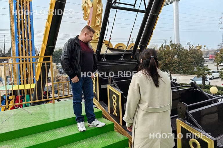Russian client testing the pirate ship ride in the factory display area to verify performance and stability