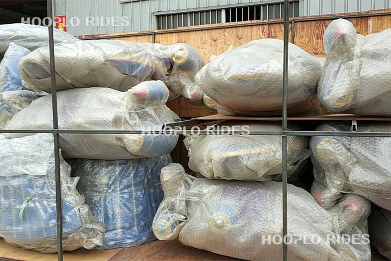 Components of self-control plane ride packed neatly into large wooden crates, ensuring safe transport.