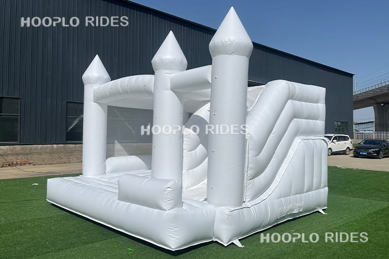 Left side view of white wedding inflatable bounce house showing elegant structure and reinforced PVC material.