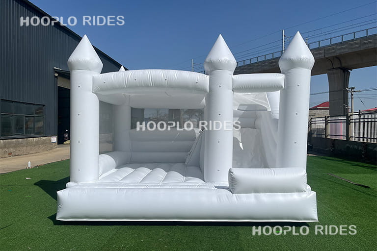 Front view of white wedding inflatable bouncer designed for luxury wedding parties and commercial event rental use.