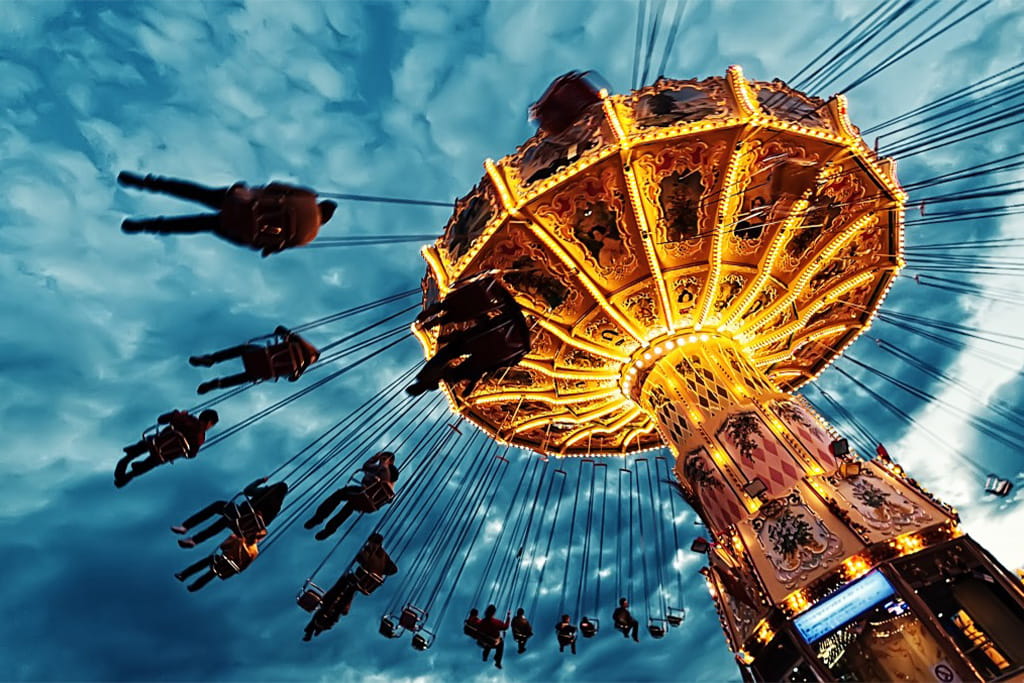 The swinging chair ride illuminated at dusk, creating a thrilling experience for park visitors.