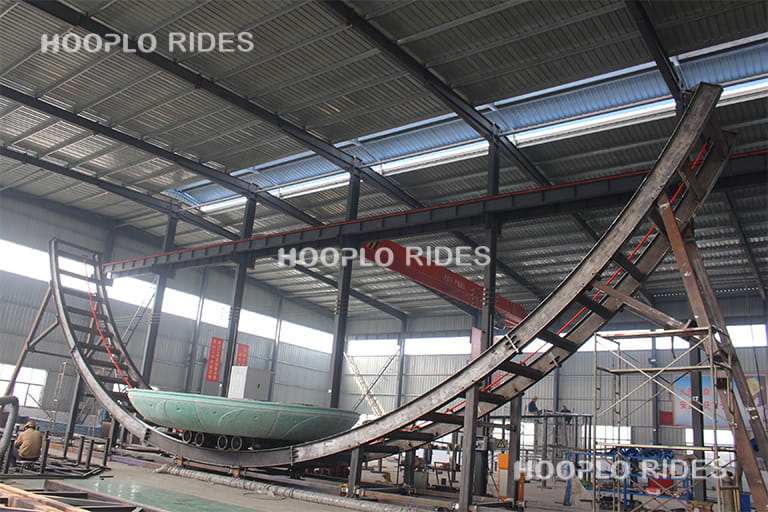 Production of a Disk'O ride in the factory workshop, showing the main structure of the amusement ride being manufactured.