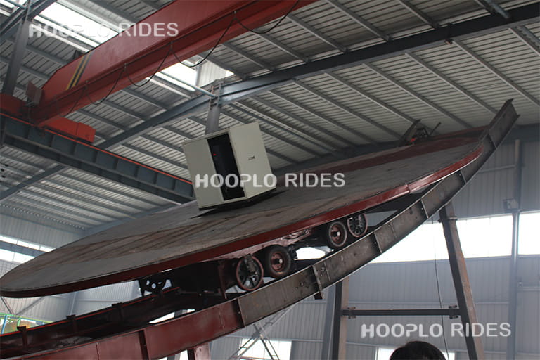 Close-up of the rotating platform structure during the manufacturing process of a Disk'O ride in the factory.