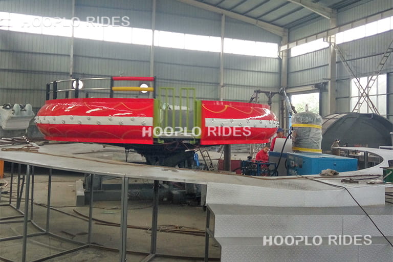 Disco Tagada Ride being manufactured in the factory workshop, showing steel platform, seats, and assembly process for quality assurance