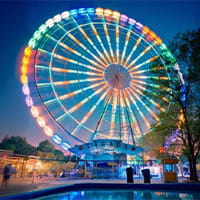 Ferris wheel illuminated at night in an amusement park