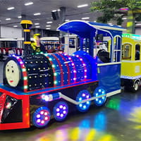 Mini train amusement ride operating in an amusement park