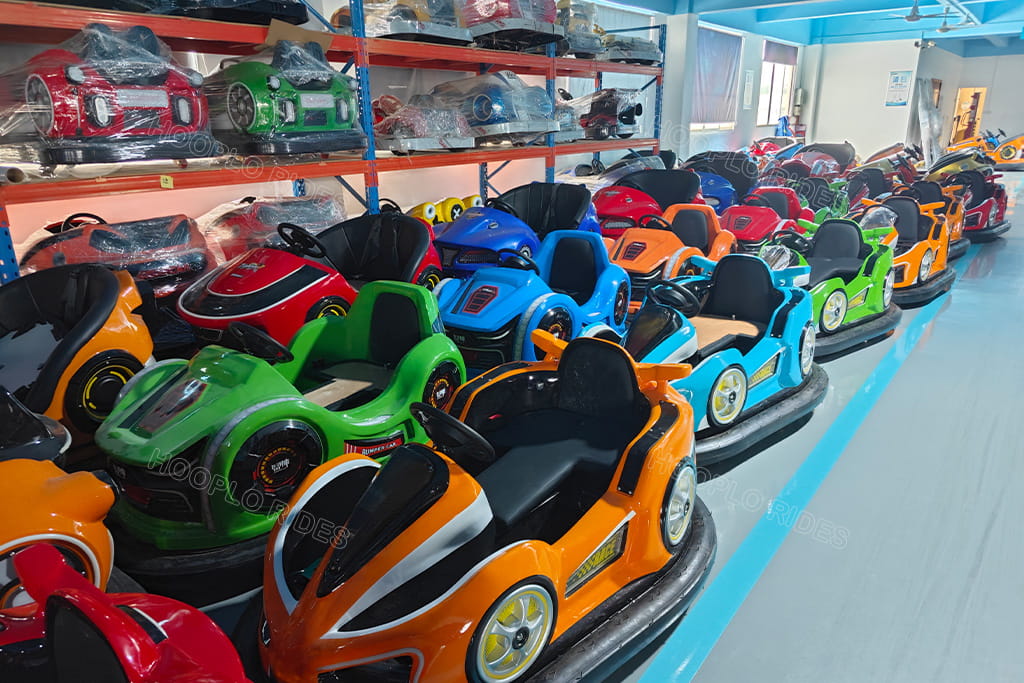 Wide view of Hooplo factory warehouse full of battery drift bumper cars, multiple colors amusement dodgem vehicles for FEC venue