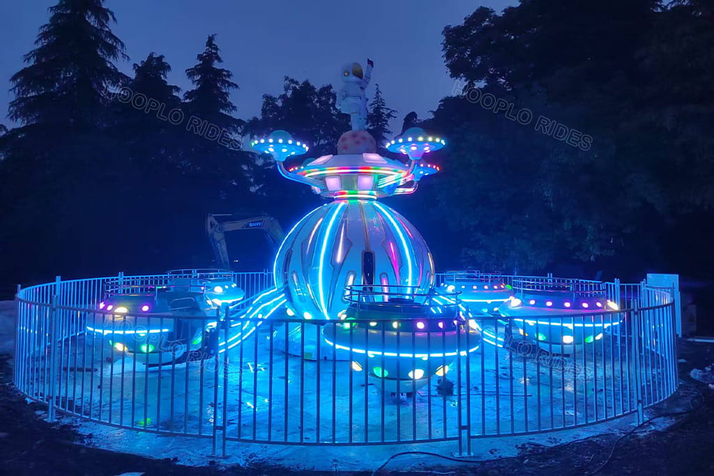 Light-up Hooplo Space UFO Self Control Plane Ride, LED neon glowing astronaut UFO amusement ride installed in outdoor park at night