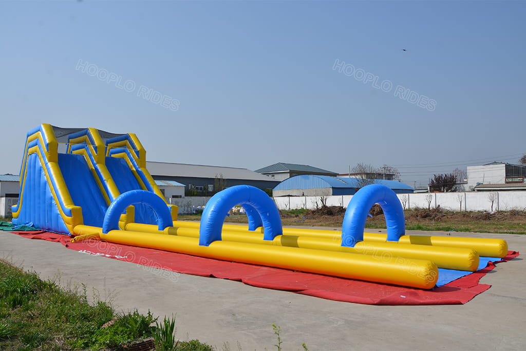 Double lane inflatable water slide attached with long inflatable obstacle running course for summer team event